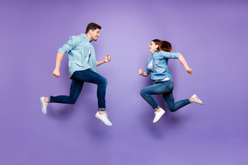 Fototapeta na wymiar Full body profile side photo of funny funky romantic brunet hair redhair married people jump run after discount feel fun wear modern spring clothes isolated over purple violet color background
