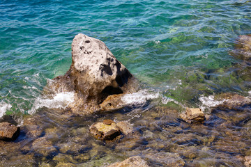 Blue water and rocky coast of the Aegean Sea as a background