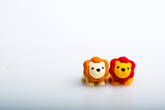 Two lion rubber toys, cute animal shaped rubber doll isolated in white background. 