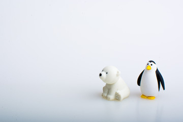 Penguin and polar bear rubber toys, cute animal shaped rubber doll isolated in white background. 