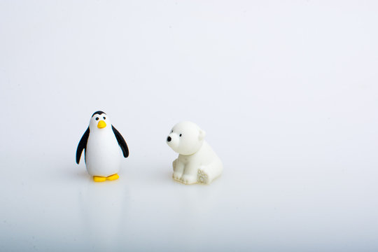 Penguin and polar bear rubber toys, cute animal shaped rubber doll isolated in white background. 