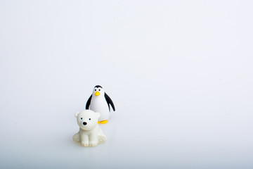 Penguin and polar bear rubber toys, cute animal shaped rubber doll isolated in white background. 