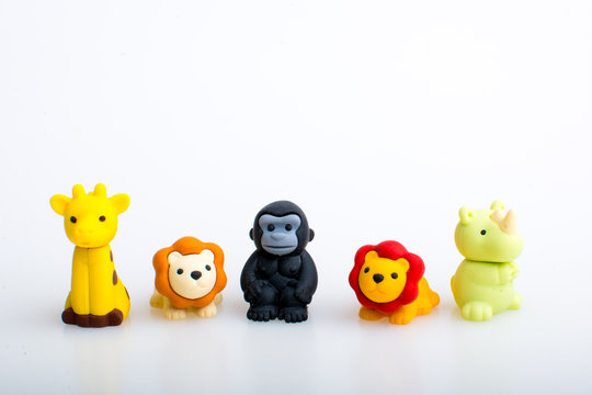 Giraffe, lion, gorilla and rhino rubber toys, cute animal shaped rubber doll isolated in white background. 