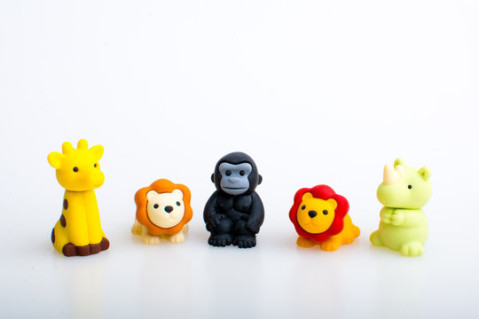 Giraffe, lion, gorilla and rhino rubber toys, cute animal shaped rubber doll isolated in white background. 
