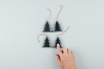 Eco wooden christmas toy. Female hands holdings holiday decoration for christmas and new year tree. Flat lay, top view