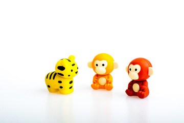 Two monkey and a tiger rubber toys, cute animal shaped rubber doll isolated in white background. 