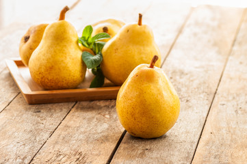 Fruit background. Fresh organic pears on old wood. Pear autumn harvest