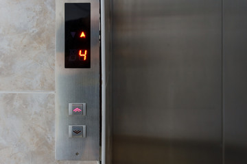 Metallic elevator panel with button and led display.  Interior and closeup of metal buttons in elevator © Илья Подопригоров