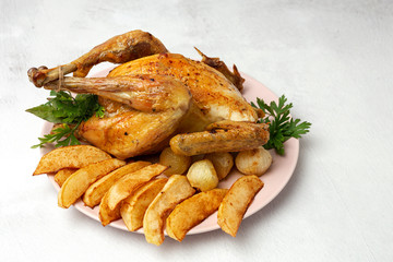 Appetizing roast chicken with garlic potatoes and onions