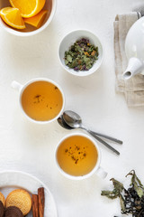 Fototapeta na wymiar Floral green tea on table with tea kettle and napkin
