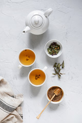 Obraz na płótnie Canvas Floral green tea on table with tea kettle and napkin