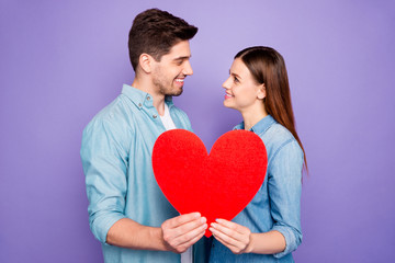 Fototapeta na wymiar Profile side photo of romantic two students married couple hold paper card heart sign of feelings gift for 14-february honeymoon wear denim jeans outfit isolated over purple violet color background