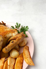Appetizing roast chicken with garlic potatoes and onions