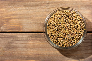 hemp seeds in glass  bowl on wooden table