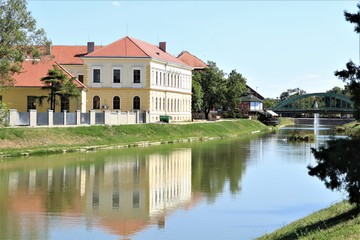 City landscape: river, bridge, old restored building.