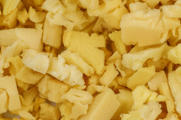 yellow polyurethane foam rubber pieces background texture. stuffing for pillows and furniture