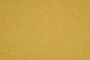 yellow polyurethane foam rubber pieces background texture. stuffing for pillows and furniture