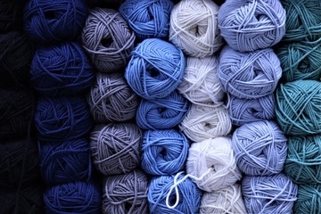 multi-colored balls of yarn: shades of blue, white, green