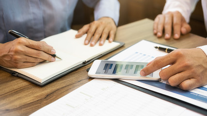Business team brainstorming and discussing with financial data and report graph. Teamwork meeting working concept.