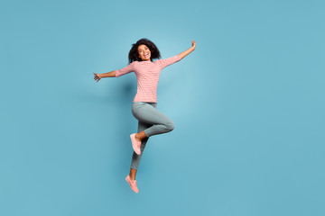 Fototapeta na wymiar Full length body size photo of cheerful cute charming nice funky girlfriend jumping up with hands raised wearing trousers pants isolated over pastel color background
