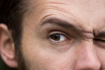 Particles on angry elder eyes with corrugated forehead