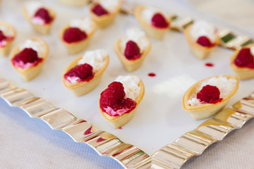 Portions of mousse creamy desserts with raspberries