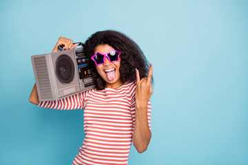 Photo of stylish trendy cheerful cute nice heavy metal fan sticking out showing you rocker sign...