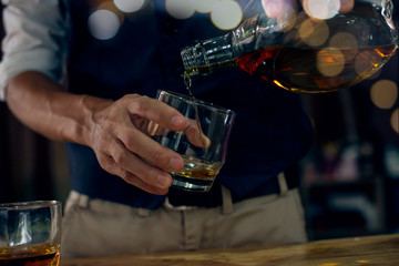 bartender pouring a drink in bar