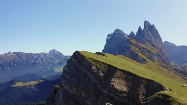 Man Alone on the Mountain Aerial 4K Footage With Seceda Ridge in the Background.Italy Dolomites 4k Footage Drone Shot in UHD 4K