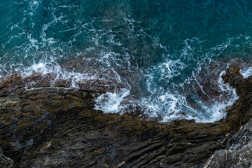 Foamy sea at a rocky shore - natural background