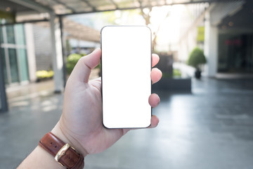 A man hand holding smart phone with blank screen. Mockup screen.