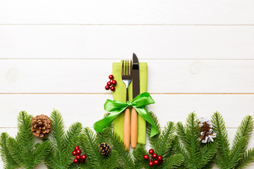 Top view of festive cutlery on new year wooden background. Christmas decorations with empty space for your design. Holiday dinner concept