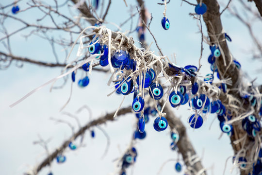 A nazar is an eye-shaped amulet believed to protect against the evil eye. A lot of nazars on the tree. Turkish anti-evil eye amulet