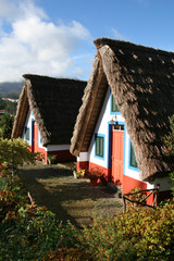 Fototapeta na wymiar Traditional Santana Houses on Madeira Island illuminated by the sun. The houses are typical for the island.