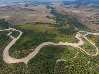 Aerial view of Kurai steppe and Chuya river on North-Chui ridge background. Altai mountains, Russia.