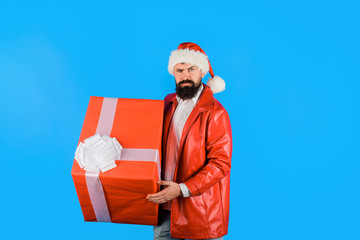 Christmas. New year gifts. Christmas decorations. Santa Claus hold big present. Smiling Santa Claus with New Year gift. New year gift. Present box.