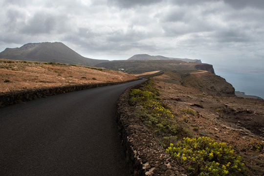 Empty road with no people on Lanzarote, Canary island, hills ahead