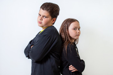 a little girl and a boy stand shoulder to shoulder