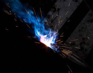 Sparks from welding at a construction site as a background