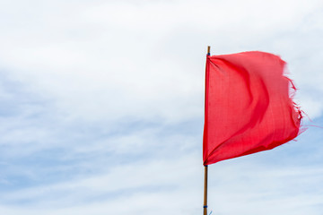 Red flag warning flags wind blue sky