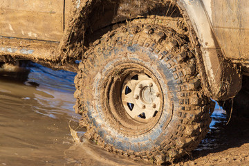 SUV wheel stalled in mud and water