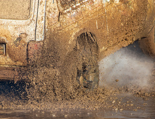SUV wheel stalled in mud and water