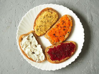 Sandwiches with cottage cheese, hummus, carrots, beets. Vegan. Healthy diet.