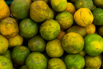 Green fresh whole ripe green tangerine as a texture. Food concept. Tropical and exotic fruits. Healthy and vitamin food concept.