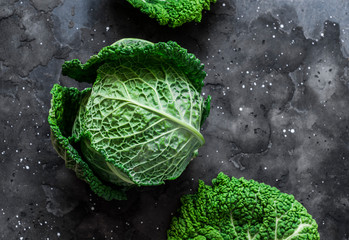 Fresh savoy cabbage on a dark background. the view from the top. Copy space - obrazy, fototapety, plakaty