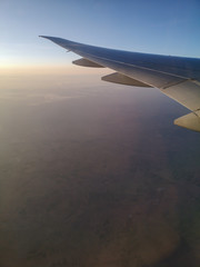 Fototapeta premium Dawn of the sun in the window of an airplane