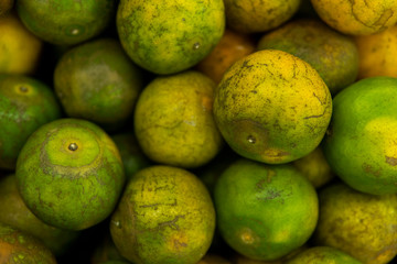 Green fresh whole ripe green tangerine as a texture. Food concept. Tropical and exotic fruits. Healthy and vitamin food concept.