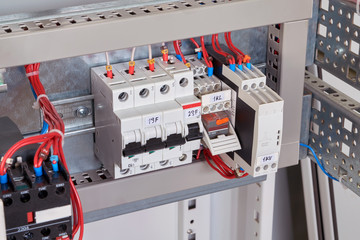 Circuit breakers, intermediate relay and phase control relay in the electrical Cabinet. Wires are connected to the electrical equipment according to the scheme. Automation of electrical equipment.