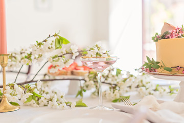 Festive wedding table with cake, champagne and snacks