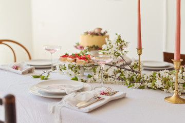Festive wedding table with cake, champagne and snacks